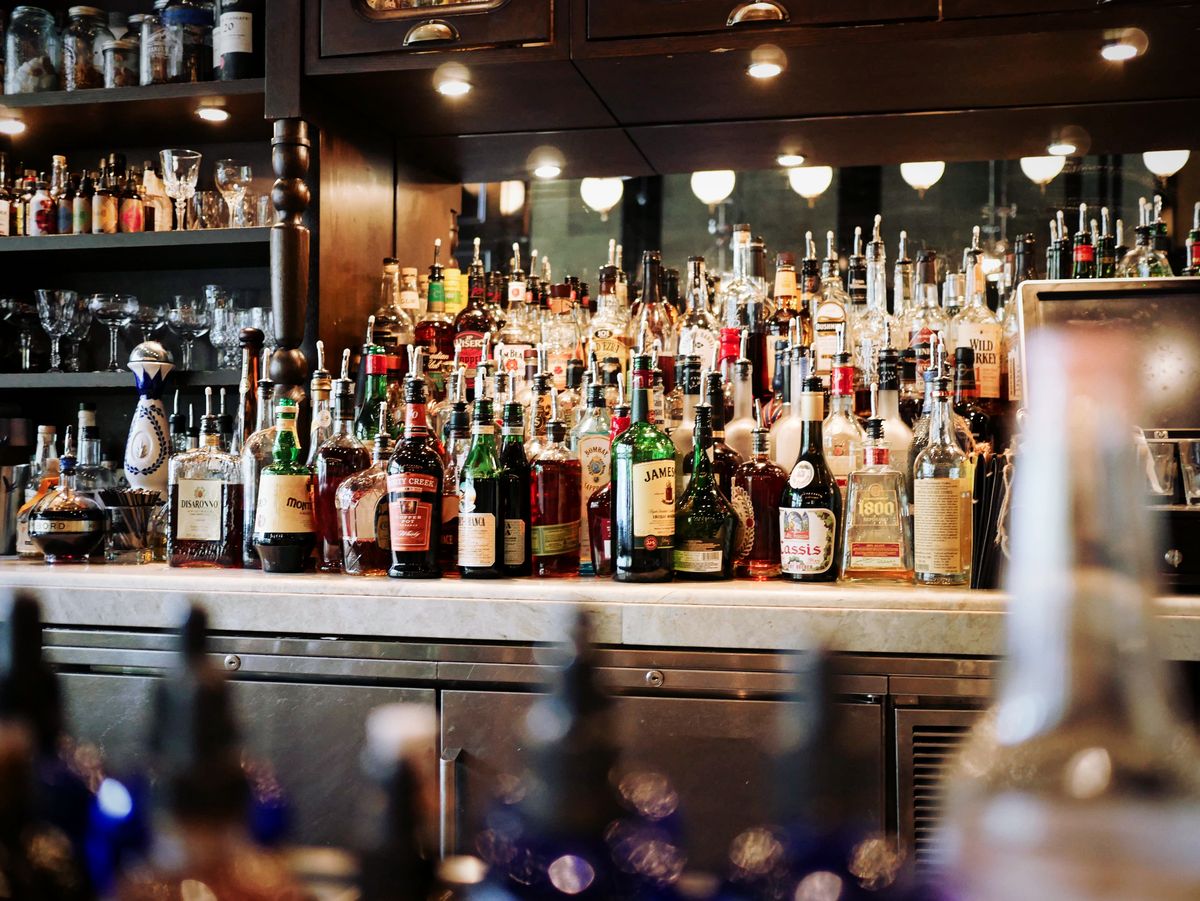 Bar area with bottles and signature cocktails on display