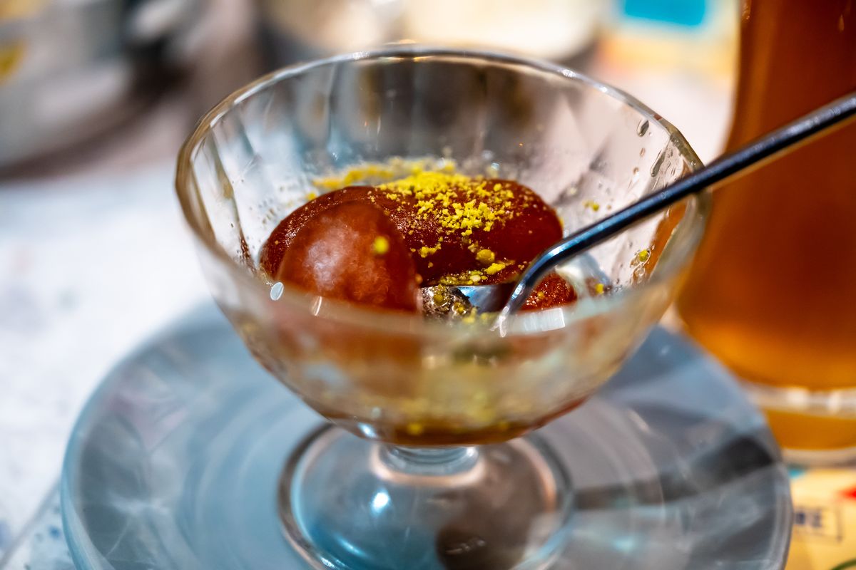 Indian dessert plated with garnish and syrup